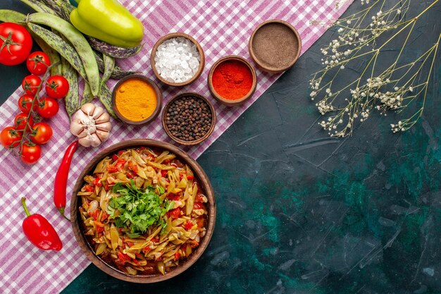 Top view sliced vegetable meal delicious beans meal with different seasonings on blue background