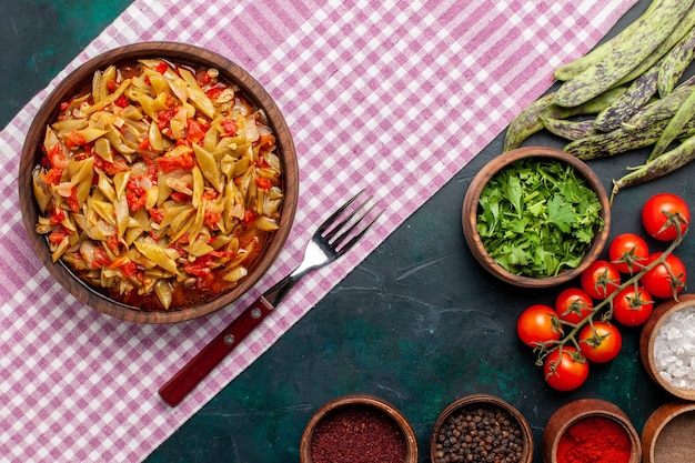 Free Photo top view sliced vegetable meal delicious beans meal with seasonings on blue background