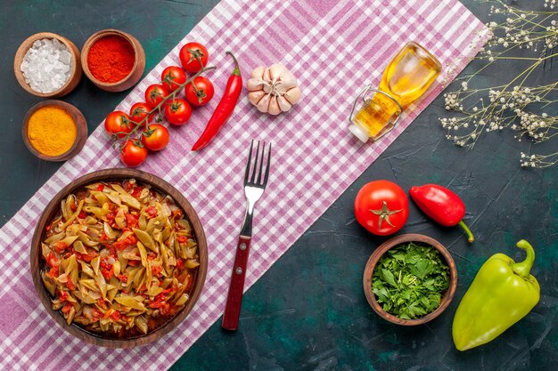 Free Photo top view sliced vegetable meal with different seasonings on dark blue background