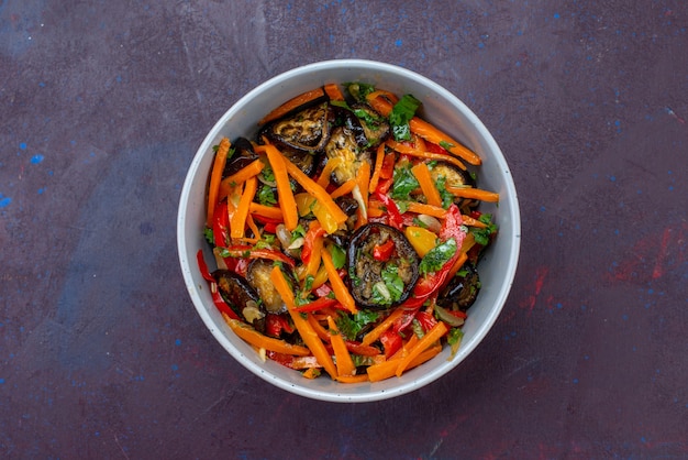 Free photo top view sliced vegetable salad inside plate on the dark-blue surface