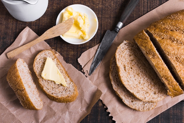 Top view slices of bread with butter and knife