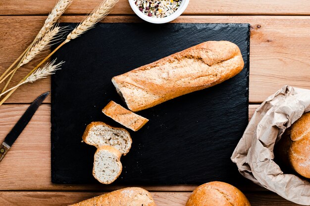 Top view of slices and bread on woden table