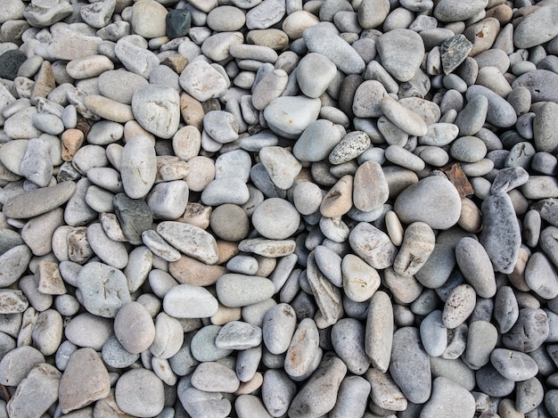 Free photo top view of small pebble stones on the beach at daytime