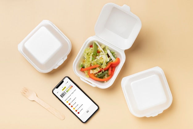 Top view smartphone and food containers