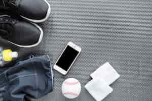 Free photo top view of smartphone surrounded with sportswear