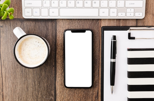 Free photo top view smartphone template over workspace