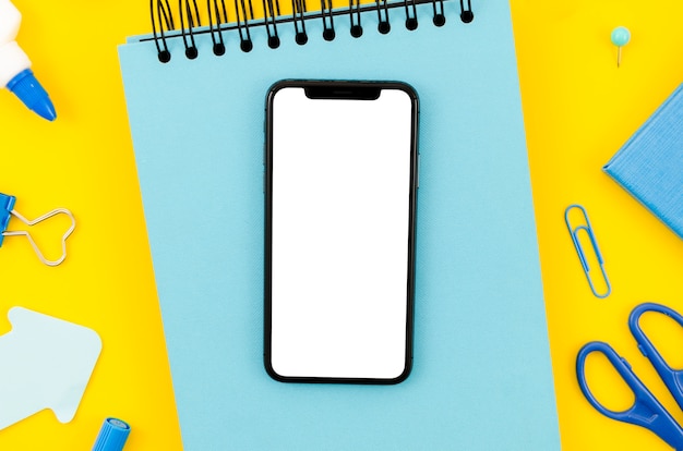 Free photo top view smartphone template over workspace