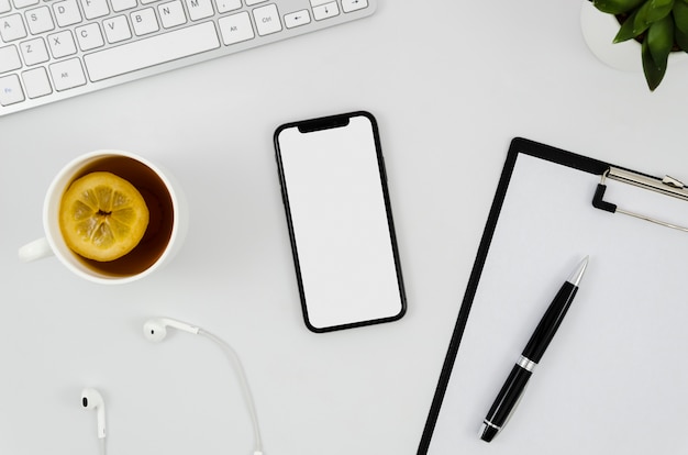 Free Photo top view smartphone template over workspace