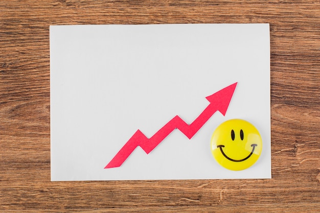 Top view of smiley face and growth arrow