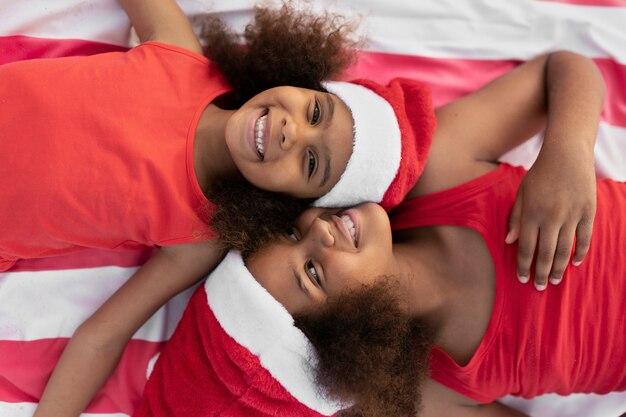 Top view smiley girls laying together