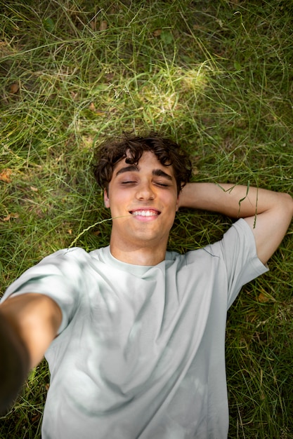 Top view smiley man taking selfie