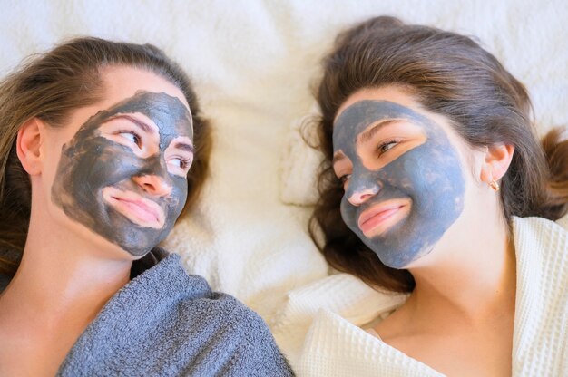 Top view of smiley woman with face masks at home