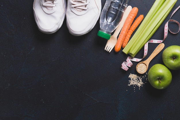 Free Photo top view of sneakers with vegetables and apples