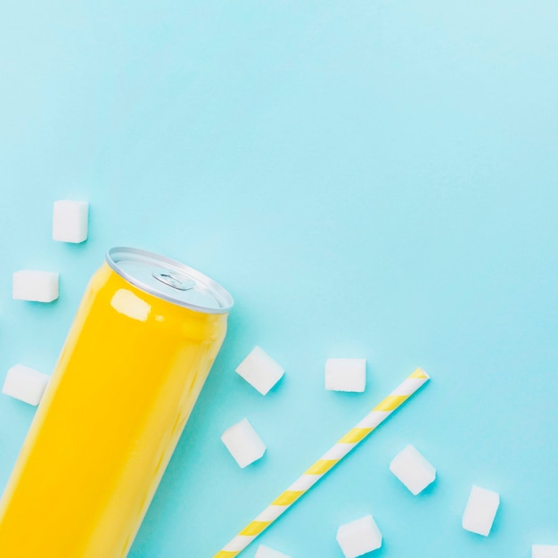 Free photo top view of soft drink can with sugar cubes and straw