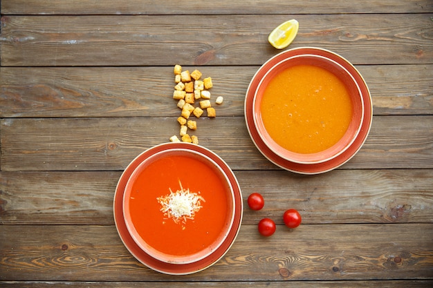 Free Photo top view of soup bowls with tomato and lentil soups in wooden background