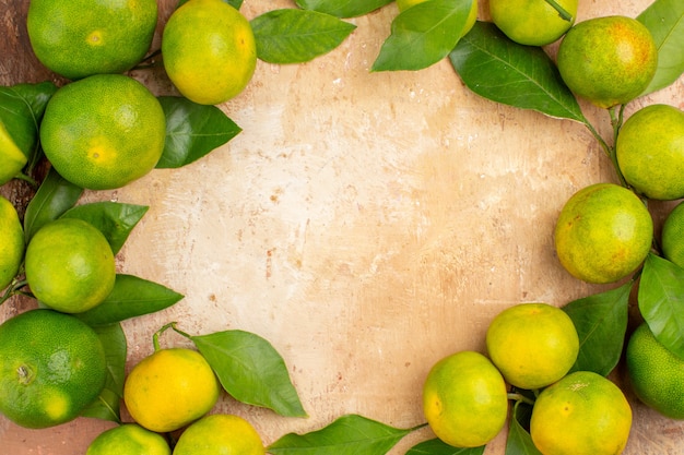 Free Photo top view sour green tangerines on a light background