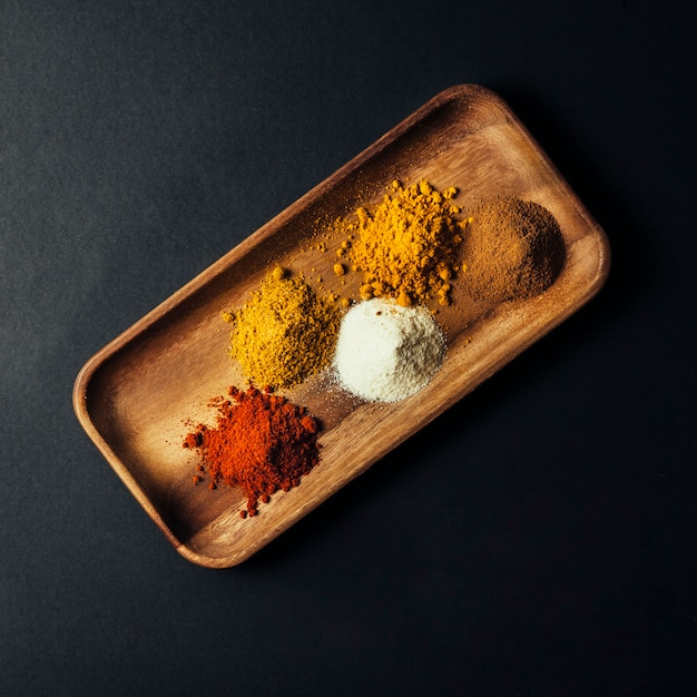 Free Photo top view of spices on wooden board