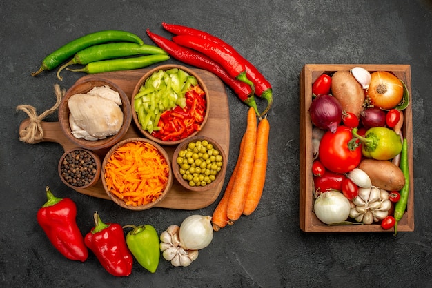 Top view spicy peppers with beans chicken and carrot on dark desk color salad ripe fresh