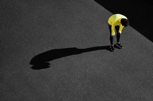 Top view of sportsman taking a break from exercising