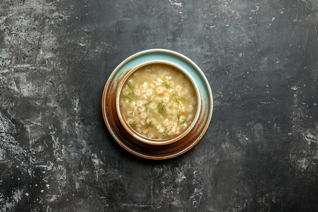 Top view star soup in bowl on dark background free space