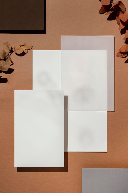 Top view of stationery papers with leaves