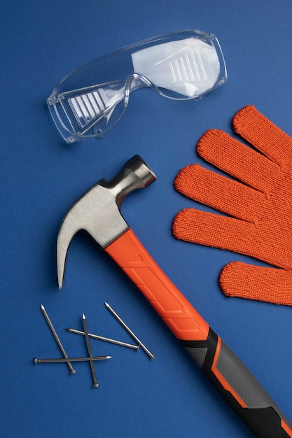 Free photo top view of steel hammer with other construction elements and tools