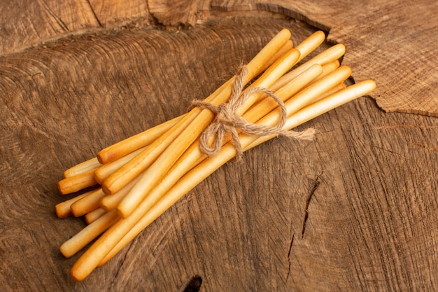 Top view stick crackers salted on the wooden desk cracker crisp snack photo