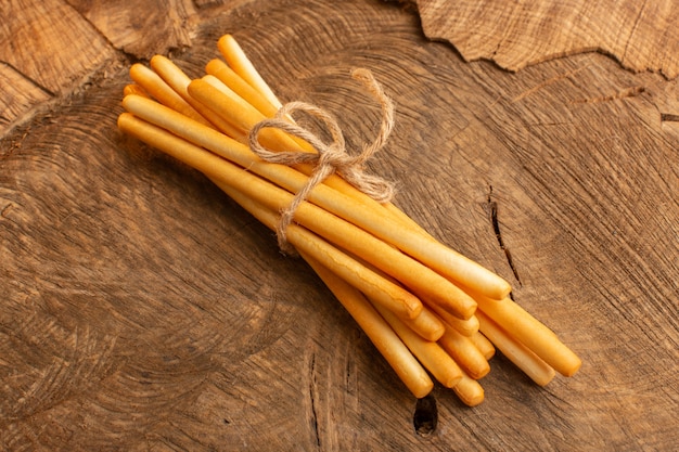 Free Photo top view stick crackers tied with thin rope on the wooden desk cracker crisp salt snack photo