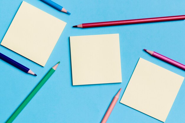 Top view sticky notes with pencils on the desk