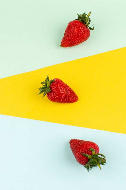 top view strawberries red mellow isolated on the colored floor