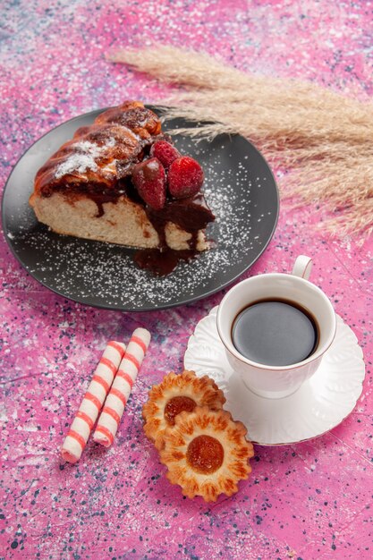 Top view strawberry chocolate cake with cup of tea and  on light pink desk