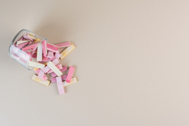 Top view of strip gums in jar on cream.