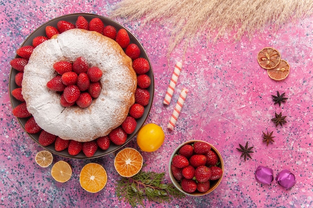 Top view sugar powdered pie strawberry cake with lemon on light pink