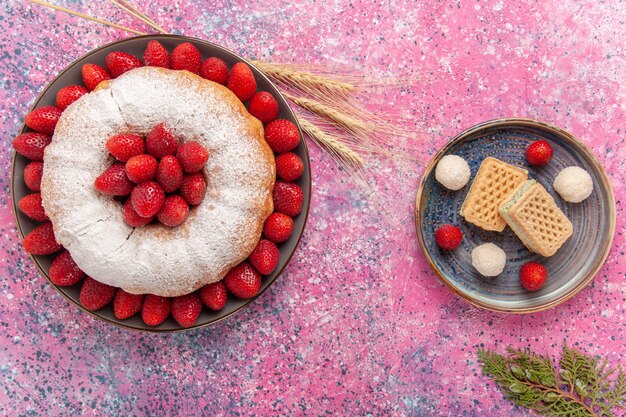 Top view sugar powdered pie strawberry cake with waffles on pink