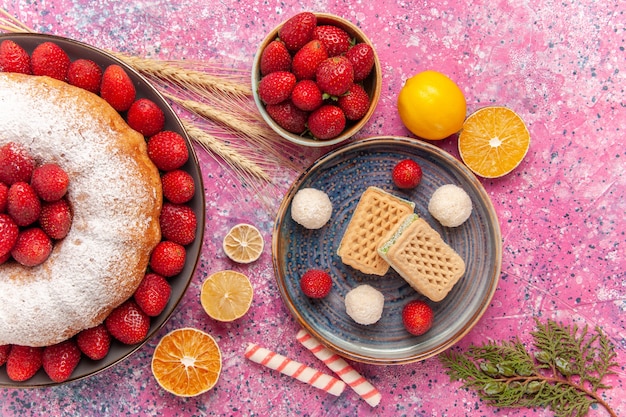 Top view sugar powdered pie strawberry cake with waffles on the pink