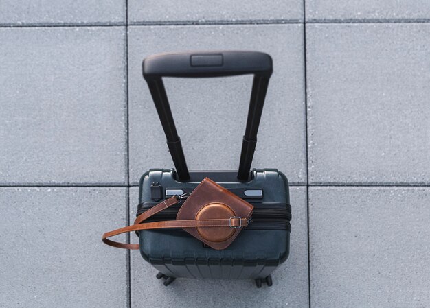 Top view of suitcase and retro camera in leather case