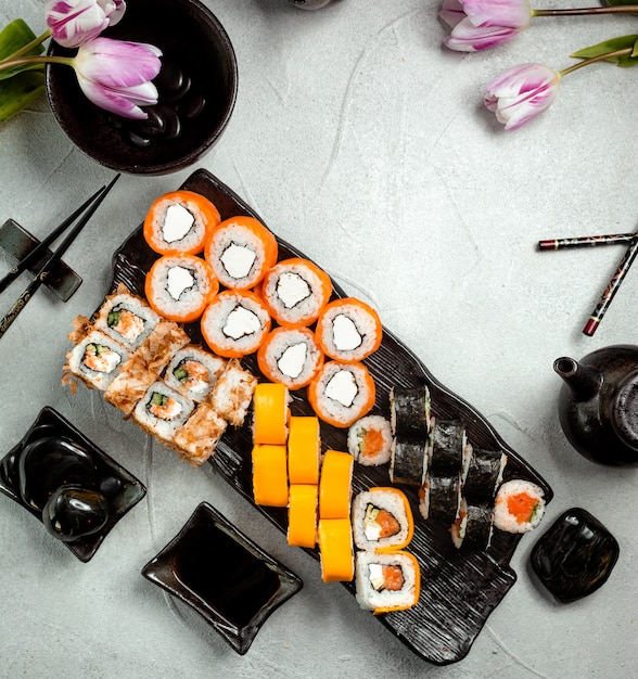 top view of sushi rolls set served with soy sauce