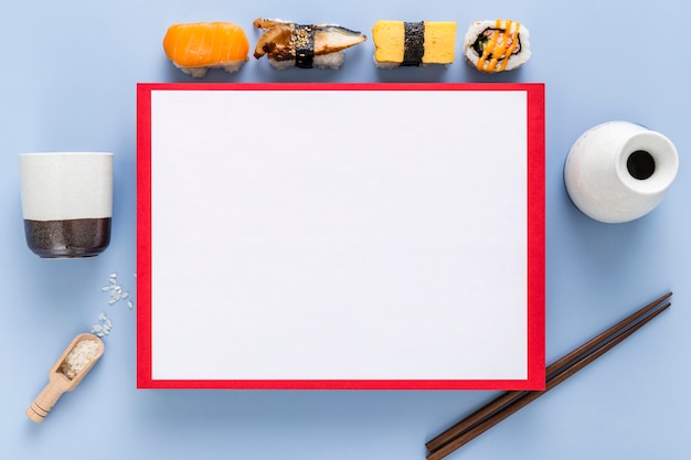 Free photo top view of sushi with blank menu and chopsticks