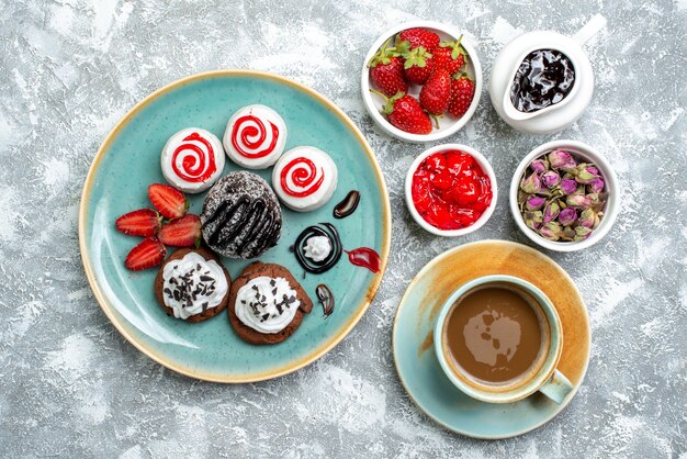 Top view sweet delicious biscuits with cup of coffee on white background biscuit sugar cake sweet cookie