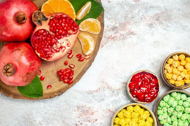 Top view sweet sugar candies with fresh fruits on a white background sugar candy fruit sweet