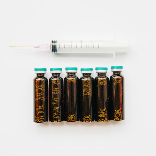 Free Photo top view syringe and vials