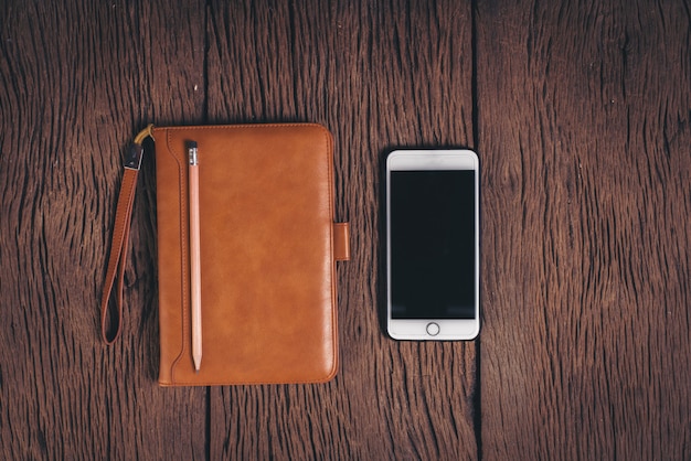 Top view Tablet computer and phone on wood background