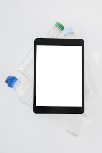 Free photo top view tablet with bottles of water