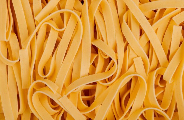 Top view of tagliatelle pasta as surface