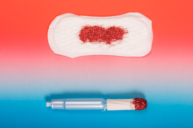 Free photo top view tampon and sanitary towel with glitter