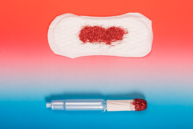 Free Photo top view tampon and sanitary towel with glitter