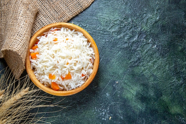 Top view tasty boiled rice inside little plate on dark desk