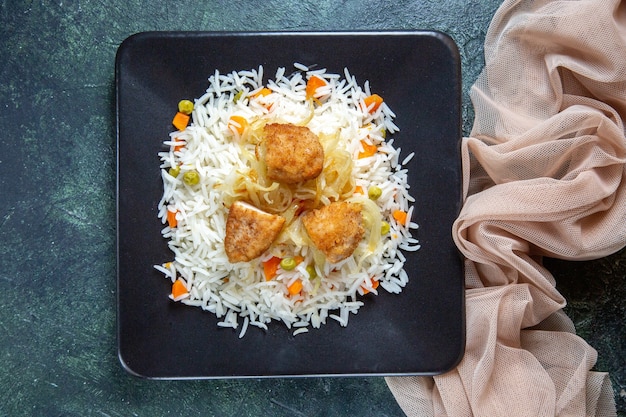 Free Photo top view tasty boiled rice with beans and meat inside plate on dark desk