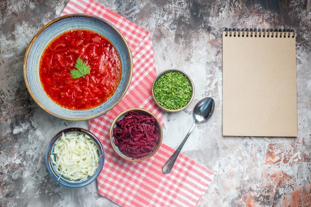 Top view of tasty borsch ukrainian beet soup inside plate on white surface