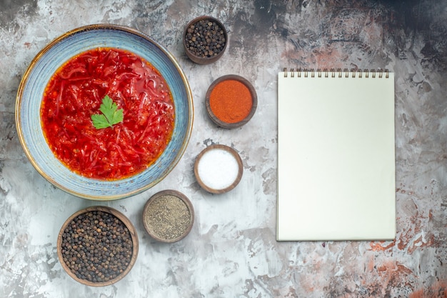 Free photo top view of tasty borsch ukrainian beet soup with seasonings on the white surface